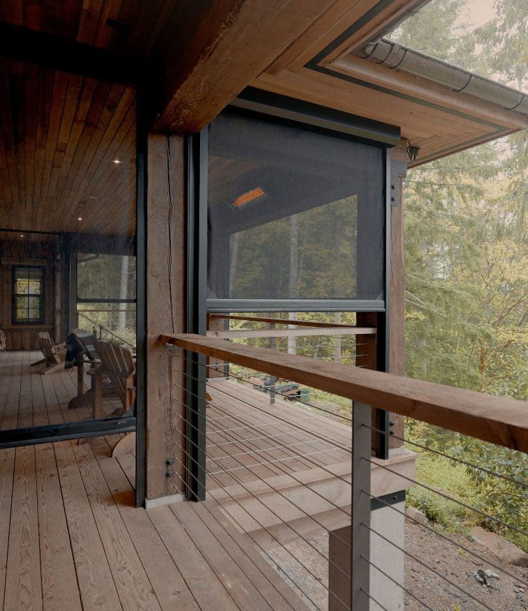 Retractable screen installed on wooden deck overlooking forest